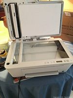 HP DeskJet 4100e printer with top lid open showing flatbed scanner glass surface and control panel