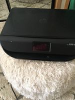 Front angled view of the HP printer showing the control panel with touchscreen.