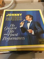 Johnny Mathis vinyl record album cover showing the singer in a blue tuxedo holding a microphone.