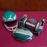 Photo showing all 3 items: green Hutch helmet, Good Stuff NY Jets football, and Rawlings Florida Gators football in package
