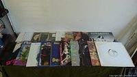 20 vinyl records laid out in two rows showing front album covers with diverse artwork and some text visible.