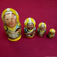 All four hand-carved and painted NFL nesting dolls displayed together showing size progression and unique player portraits in Green Bay Packers gear.