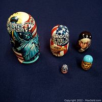 Full set of 5 wooden nesting dolls with patriotic United States designs including Statue of Liberty, eagle, and figures.