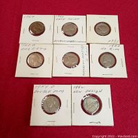 Eight Jefferson 5 Cent coins displayed in flips showing obverse side with dates and notes on coin specific characteristics.