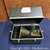 Super hailer device inside original black carrying case showing microphone and horn speaker.