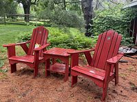 Full set of two Adirondack chairs and side table outdoors on pine straw