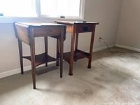 Both end tables placed side by side showing front and side angles with visible wood grain and drawer details