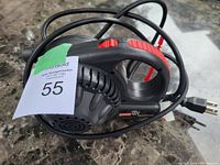 Photo of the Coleman QuickPump electric air compressor showing body, power cord, and handle with control switch.