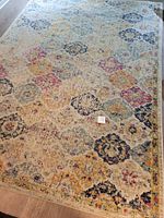 Full view of rug on hardwood floor showing overall pattern and color distribution