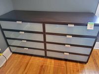Front view of the Ikea Hopen dresser showing eight drawers with frosted glass fronts and aluminum handles in espresso finish.