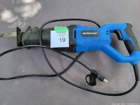 Full side view of blue and black Mastercraft corded reciprocating saw with power cord and visible saw blade.