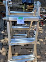 Front view of folded ladder showing rungs and locking hinges