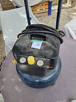 Front view of compressor with coiled hose on top