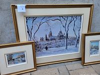 All three framed prints: one large center print flanked by two smaller prints, leaning outdoors against wall