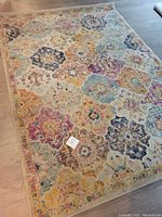 Full view of the Surya Harput area rug showing floral and geometric multicolor pattern and size.