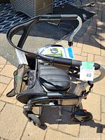 Top angled side view of the Evolution Trillium rollator walker showing padded seat and handle with brake lever.