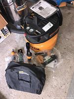 Compressor front with top controls, pressure gauges, tag and instruction manual