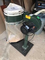 Overall view of dust extractor mounted on base with fabric and plastic bags