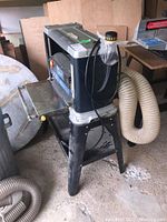 Overall view of the Mastercraft planer on stand with dust hose