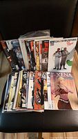 Photo showing a mixed set of comic books with various titles including Ghostbusters Royal and Xena Warrior Princess.
