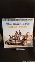 Front cover of The Beach Boys Surfin' Safari double LP gatefold set with band members and surfboard on car.