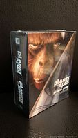 Front angled view of sealed Planet of the Apes Blu-ray 5-movie collection box set showing ape face artwork.