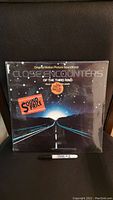 Front cover of sealed Close Encounters soundtrack vinyl album showing night road scene and Sound Price sticker