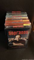 Photo showing stacked DVD boxed sets of The Sopranos series, with the first season in front featuring Tony Soprano on the cover.