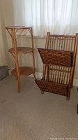 Wicker side table and two-tiered wicker magazine rack positioned on carpet near window with natural light.