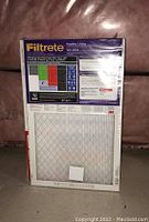 Photo showing stacked air filters in original packaging, size label and brand visible