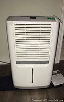 Full front view of Frigidaire dehumidifier showing body and air vent.