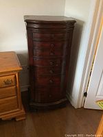 Front view of tall curved-front jewelry stand