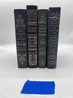 Front view of four Easton Press leather bound books standing upright showing spine titles and gold embossing.