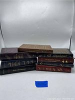 Books front view showing spines with titles and gold gilt on leather covers
