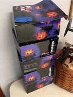 Three stacked boxes featuring images of the flower-shaped floating candle holders in use at night, floating on water with candles lit, showing the ambiance effect.