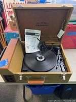 Full view of Crosley Stack-O-Matic record player in open suitcase case on table.