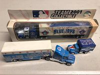 Photo showing sealed Team 2001 Collectible Toronto Blue Jays semi-truck in box with two smaller Blue Jays toy trucks in front