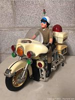 Front angle view showing the motorcycle and rider, highlighting the front lights and police decals.