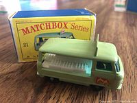 Front right angle view of the vintage Matchbox Commer Bottle Float truck with original box behind it, showing truck details and bottle crates.