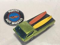 Top view showing the Deora car and button badge together