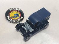Front-side view of diecast Paddy Wagon and badge