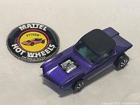 Car and button badge together on neutral background