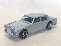 Front and left side view of the silver Hot Wheels Rolls Royce Redline car showing grille and front bumper details with slight paint wear.
