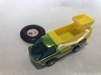 Scooper car alongside round button/badge on white background