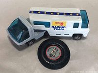 Trailer and button/badge displayed together from front angle