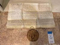 Full open vellum document with hanging circular metal seal