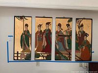 Front view of the 4-piece Japanese picture set mounted on wall, showing traditional figures on gold background
