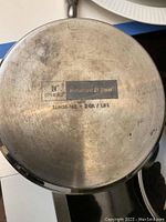 Close-up photo of the bottom of a Chantal induction compatible pot, showing brand and model information.