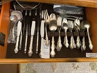 Full drawer view showing knives, forks, spoons, serving utensils and ladles