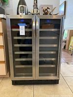 Front view of closed dual-zone cooler showing doors, handles and digital displays